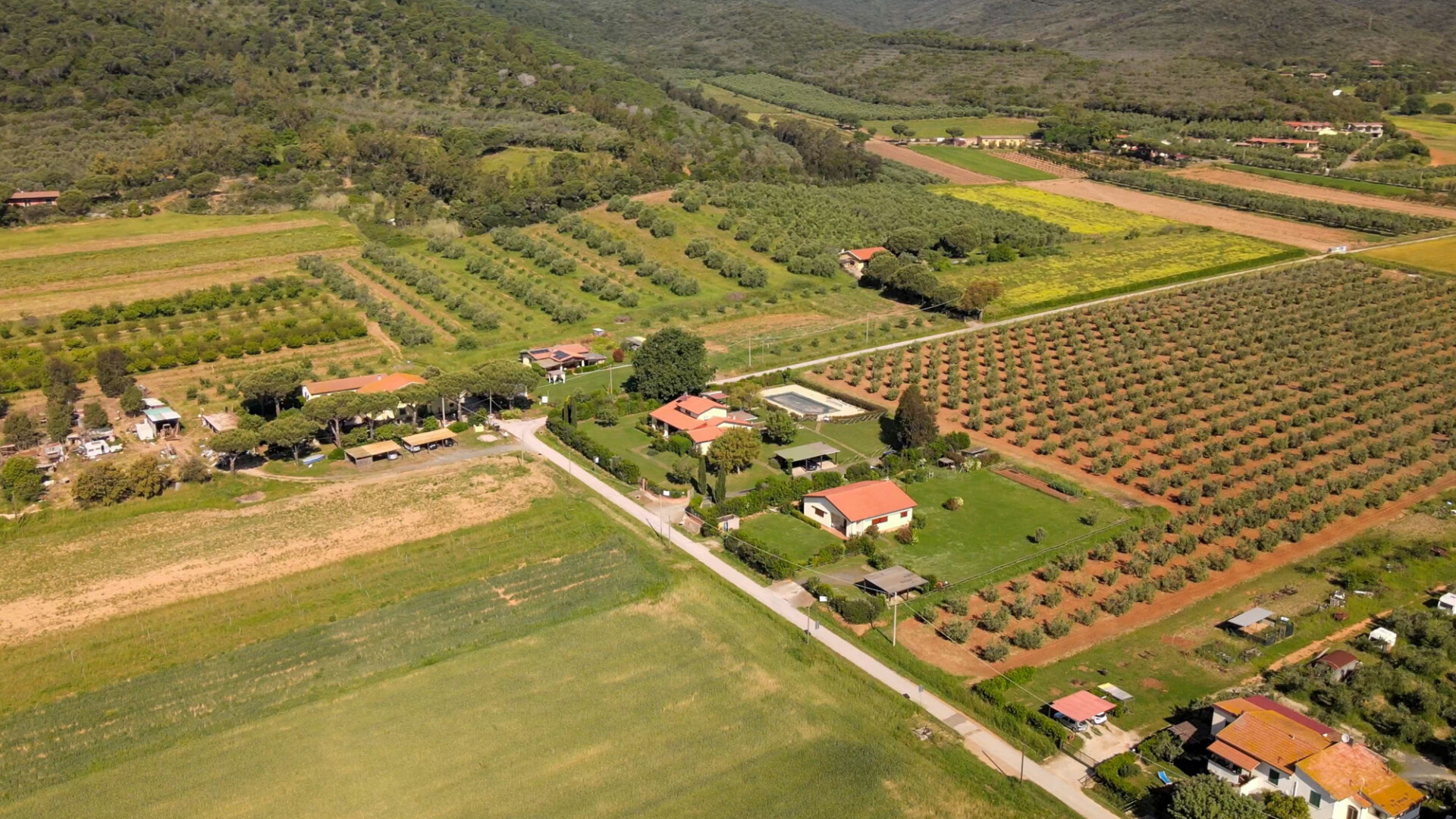 Aerial view of a beautiful Tuscany countryside landscape in spring season. Meadows and blue sky, Italy.