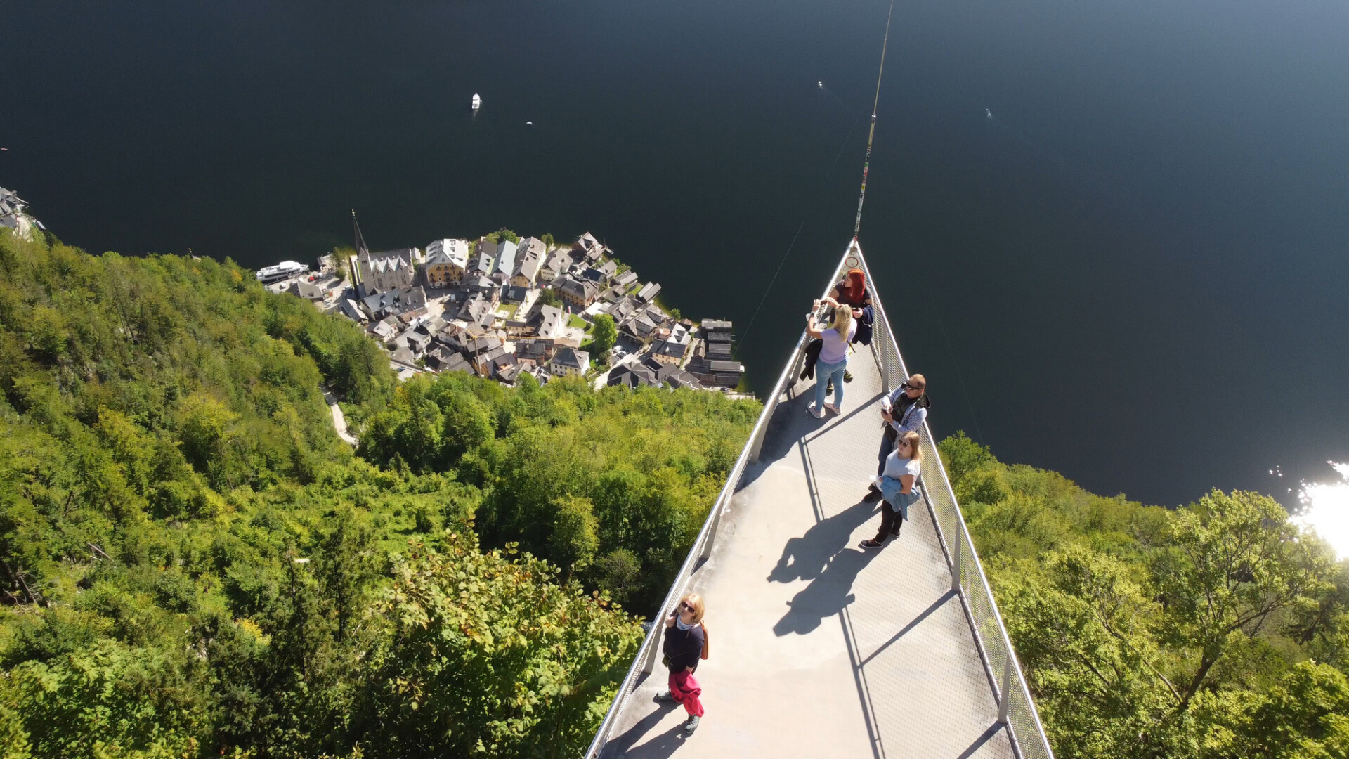Hallstatt, Austria - September 2nd, 2021: Tourists enjoy the city and lake view from mountain platform.