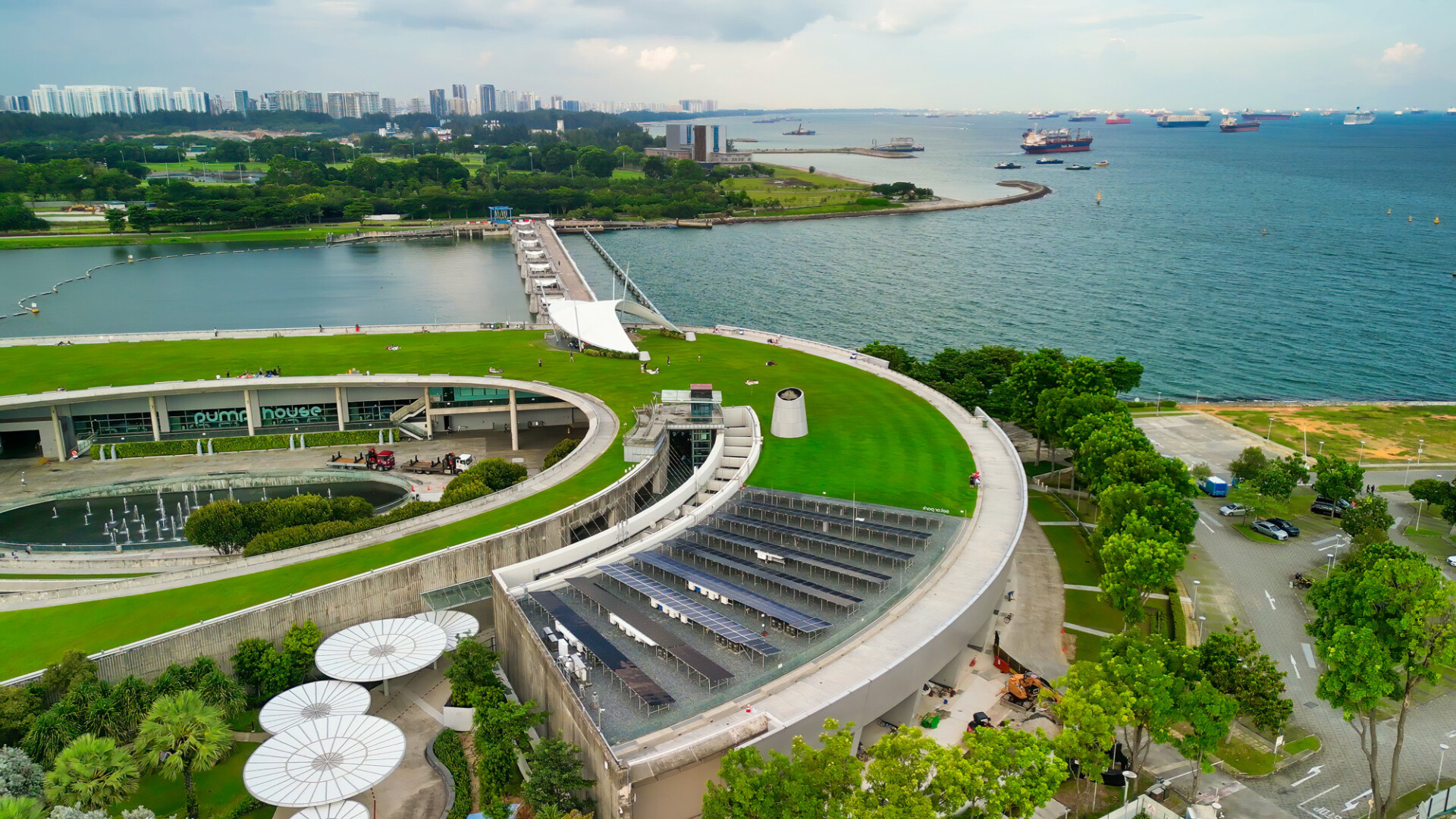Singapore - September 13, 2023: Aerial view of Marina Barrage cityscape and coastline on a overcast afternoon.