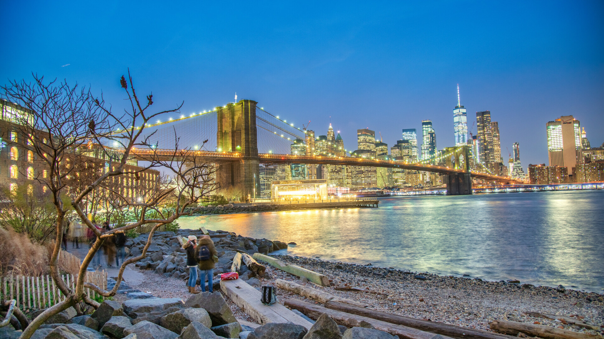 NEW YORK CITY - DECEMBER 6TH, 2018: Night view of Brooklyn Bridge and Lower Manhattan from Brooklyn district, New York City