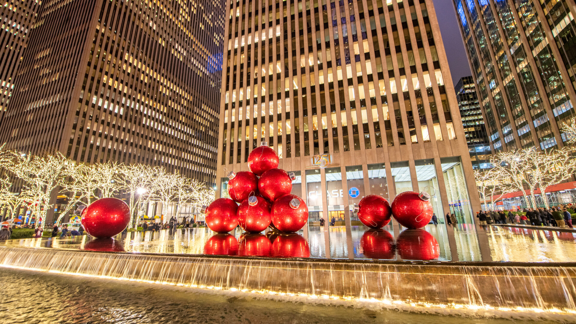 NEW YORK CITY - MOVEMBER 30TH, 2018: Giant red Christmas Balls over a fountain in front of Chase Bank at night