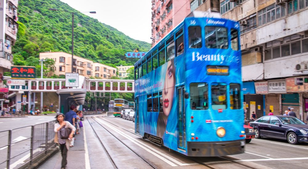 HONG KONG - MAY 11. 2014: Narrow street bus along Hong Kong roads